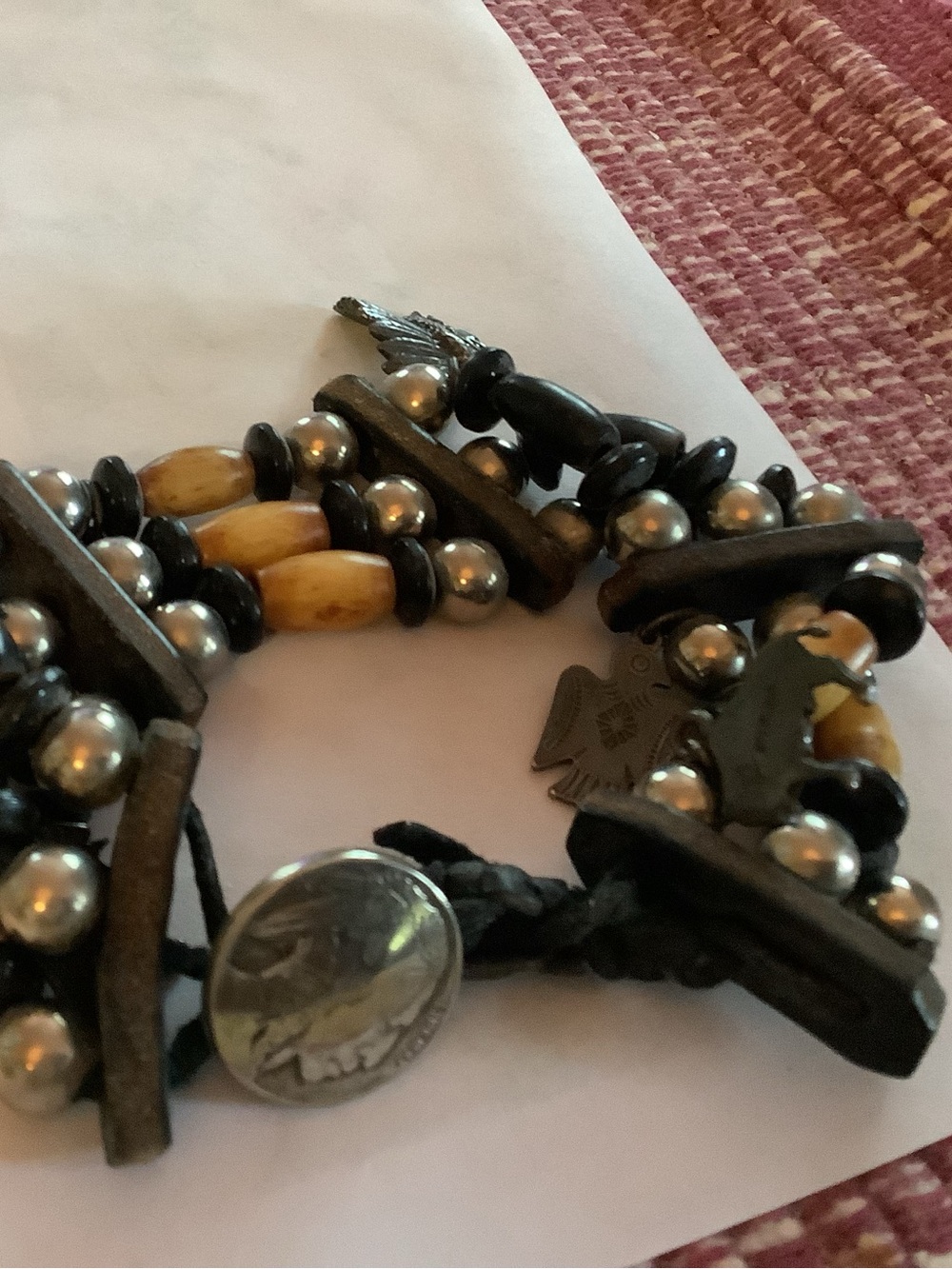 Beaded bracelet with 5 silver charms ( western motif) and Indian head  clasp